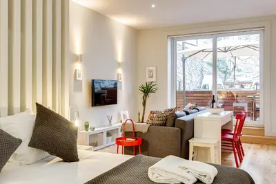 a bedroom with a bed and a living room at Pinheiro Terrace Downtown Apartment by DA'HOME in Porto