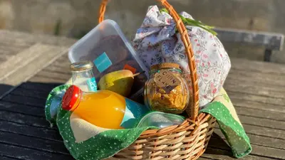 a basket filled with food and a bottle on a table at Pinheiro Terrace Downtown Apartment by DA'HOME in Porto