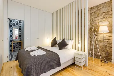 a bedroom with a bed with towels on it at Pinheiro Terrace Downtown Apartment by DA'HOME in Porto