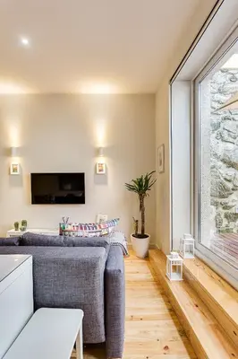 a living room with a couch and a large window at Pinheiro Terrace Downtown Apartment by DA'HOME in Porto