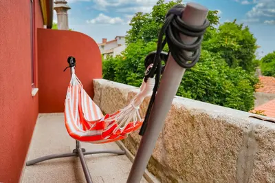 a hammock on a balcony with a red and white at Nomad's Fine Arts Collection in Porto