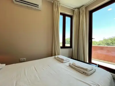 a bedroom with two towels on a bed with a window at Nomad's Fine Arts Collection in Porto