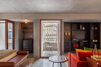 a living room with a red couch and a window at S.Bento Residences in Porto