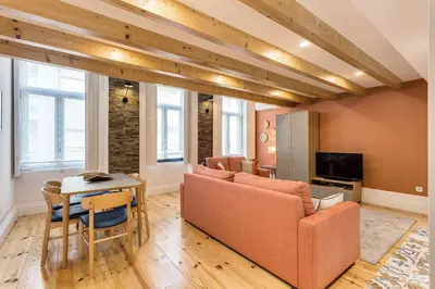 a living room with a couch and a table at Hopstays Oporto Tiles 2 - City Center Duplex in Porto