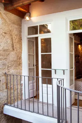 a front door of a house with a balcony at Old City Oporto in Porto