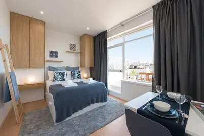 a hotel room with a bed and a large window at Oporto Dinis Apartment - Rooftop in Porto