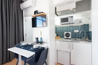 a small kitchen with a table and chairs in a room at Oporto Dinis Apartment - Rooftop in Porto