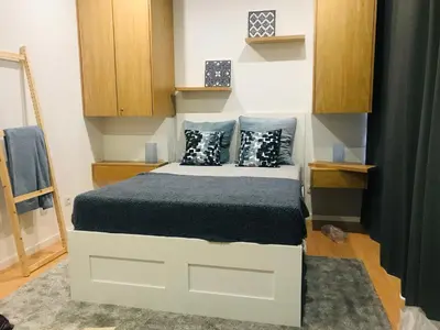 a small bedroom with a bed with blue pillows at Oporto Dinis Apartment - Rooftop in Porto