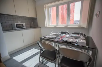 a kitchen with a table with wine glasses on it at Oporto Cool - Praça da Batalha in Porto