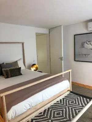 a bedroom with a large bed and a rug at Oporto Chic&Cozy - Ateneu in Porto