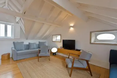 a living room with a couch and a tv at APOSENTUS - Architect and design apartment in Porto