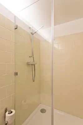 a shower with a glass door in a bathroom at APOSENTUS - Architect and design apartment in Porto