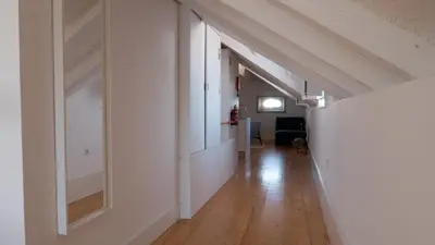 an empty hallway with white walls and wood floors at APOSENTUS - Architect and design apartment in Porto