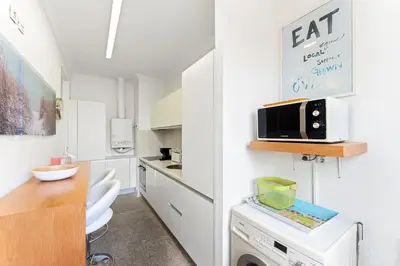 a small kitchen with white cabinets and a counter at GuestReady - Ribeira Apt in Porto center in Porto
