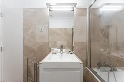 a white sink in a bathroom with a mirror at GuestReady - Ribeira Apt in Porto center in Porto