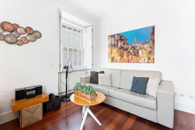 a living room with a flat screen tv and a table at GuestReady - Ribeira Apt in Porto center in Porto