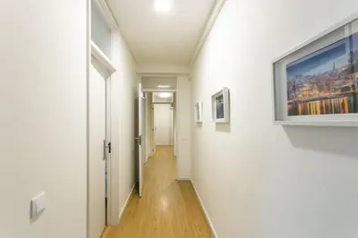 a hallway in a building with a painting on the wall at APOSENTUS - Elegant Functionality Porto Downtown in Porto