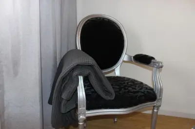 a chair with a towel on the back of it at APOSENTUS - Elegant Functionality Porto Downtown in Porto