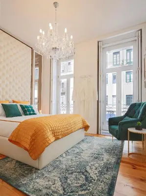a bedroom with a bed and a chandelier at Esmeralda Apartment by Cozy Stay in Porto