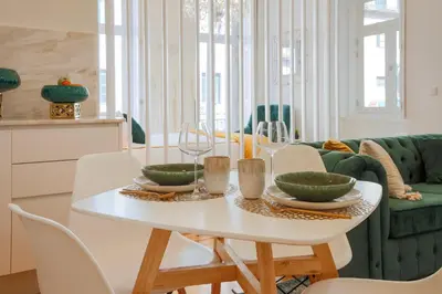 a white dining room with a white table and chairs at Esmeralda Apartment by Cozy Stay in Porto