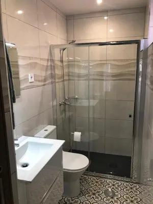 a bathroom with a shower and a toilet and a sink at OPORTO APARTMENT LUXURY in Porto