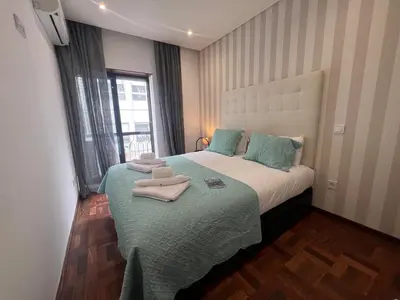 a bedroom with a bed with towels on it at OPORTO APARTMENT LUXURY in Porto