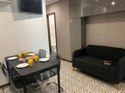 a living room with a black table and a couch at OPORTO APARTMENT LUXURY in Porto