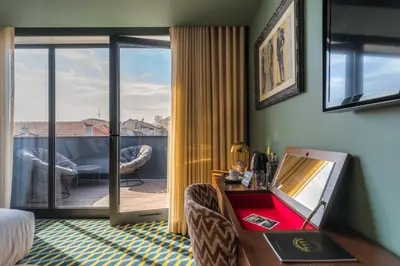 a hotel room with a bed and a desk at The Convo Porto Hotel & Apartments in Porto