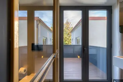 a glass door leading to a balcony in a house at The Convo Porto Hotel & Apartments in Porto