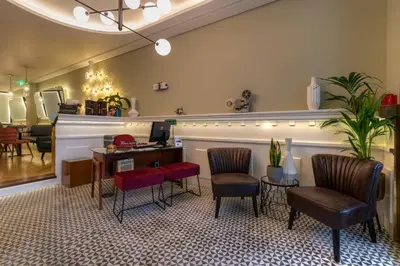a waiting room with two chairs and a piano at The Convo Porto Hotel & Apartments in Porto