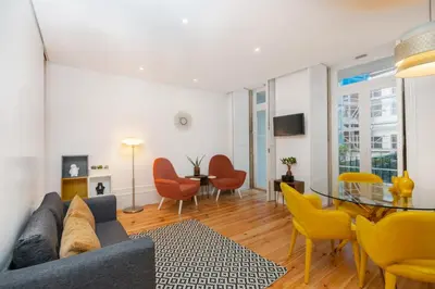 a living room with a couch and chairs and a table at Low Cost Parking - Private Garden - Almada 392 in Porto