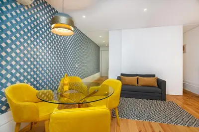 a living room with yellow chairs and a glass table at Low Cost Parking - Private Garden - Almada 392 in Porto