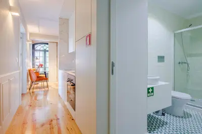 a bathroom with a toilet and a glass shower at Barão Oporto Apartments in Porto