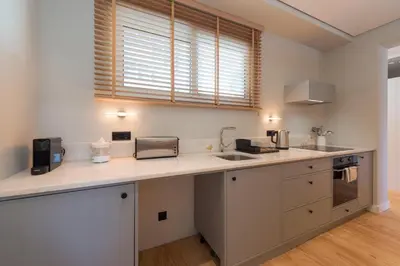 a kitchen with a counter with a sink and a microwave at Ceuta 33 Apartment in Porto