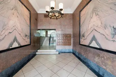 a hallway with paintings on the walls and a chandelier at Ceuta 33 Apartment in Porto