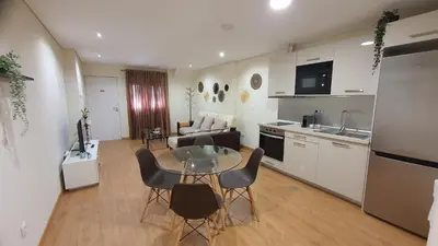 a kitchen and a living room with a table and chairs at Marques Garden with PARKING in Porto