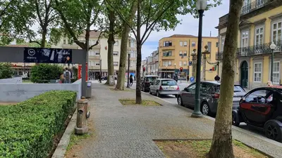a sidewalk with cars parked on a city street at Marques Garden with PARKING in Porto