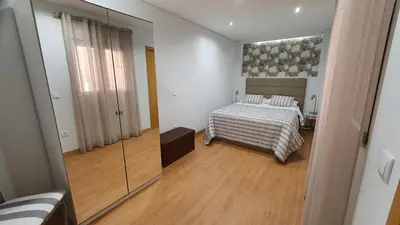 a bedroom with a bed and a mirror at Marques Garden with PARKING in Porto