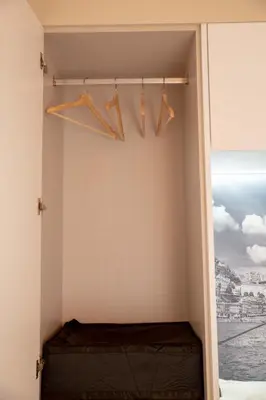 a room with hangers in a room with a window at Oporto Ana's Studio in Porto