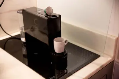 a coffee maker with a cup on a counter at Oporto Ana's Studio in Porto