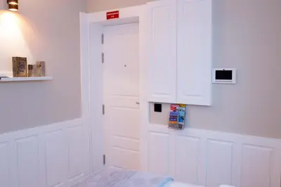 a room with a white cabinet and a door at Oporto Ana's Studio in Porto