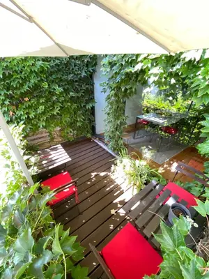 a patio with red chairs and tables and ivy at Casa 45 Porto in Porto