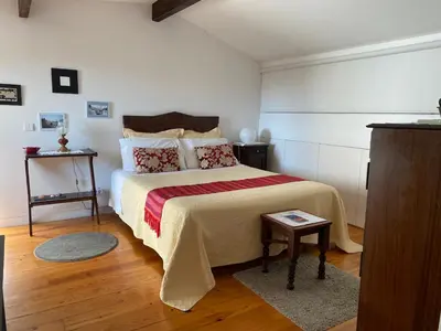a bedroom with a large bed and a table at Casa 45 Porto in Porto