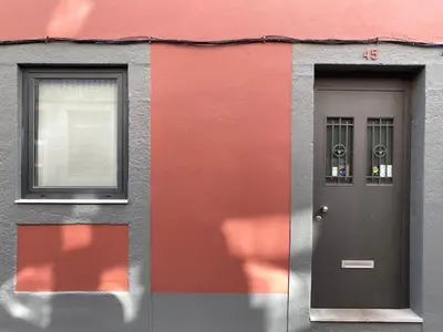a red building with a door and a window at Casa 45 Porto in Porto