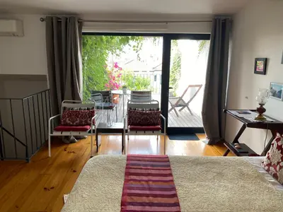 a living room with a bed and a sliding glass door at Casa 45 Porto in Porto