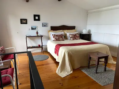 a bedroom with a bed with a red and white blanket at Casa 45 Porto in Porto