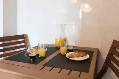 a table with a plate of bread and glasses of orange juice at LovelyStay - Homey Feeling Flat w/ Free Parking in Porto