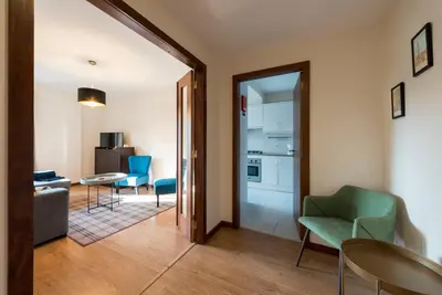 a living room with a table and chairs and a kitchen at LovelyStay - Homey Feeling Flat w/ Free Parking in Porto