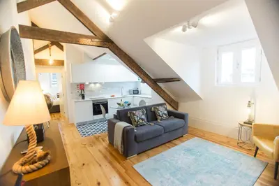 a living room with a couch and a table at Loft da Sé by Porto City Hosts in Porto