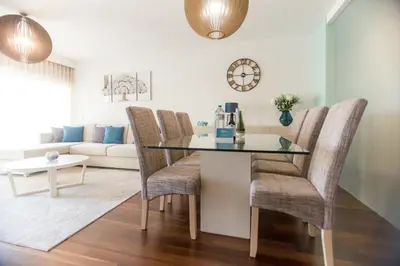 a dining room with a glass table and chairs at Afurada premium apartment by Porto City Hosts in Vila Nova de Gaia